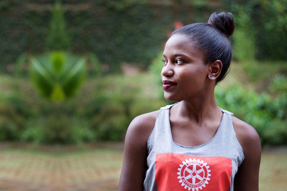 A young woman wearing a Rotary International shirt, from the film Two Drops of Patience