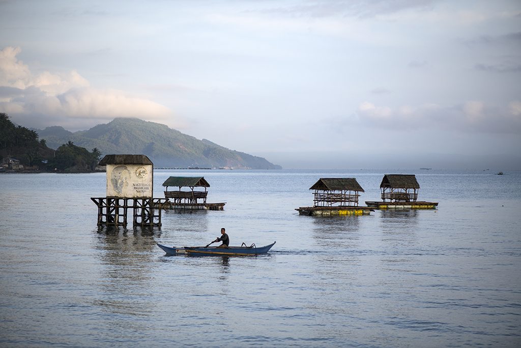 A stilt-house fishing community on the water at dawn