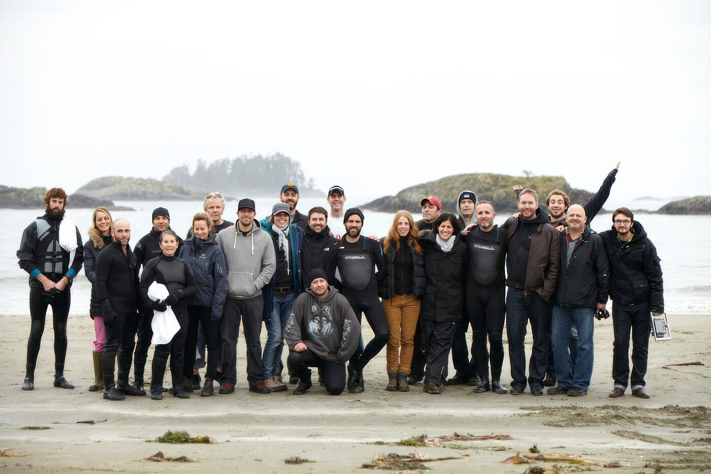 The campaign cast and crew gathered on the beach on location