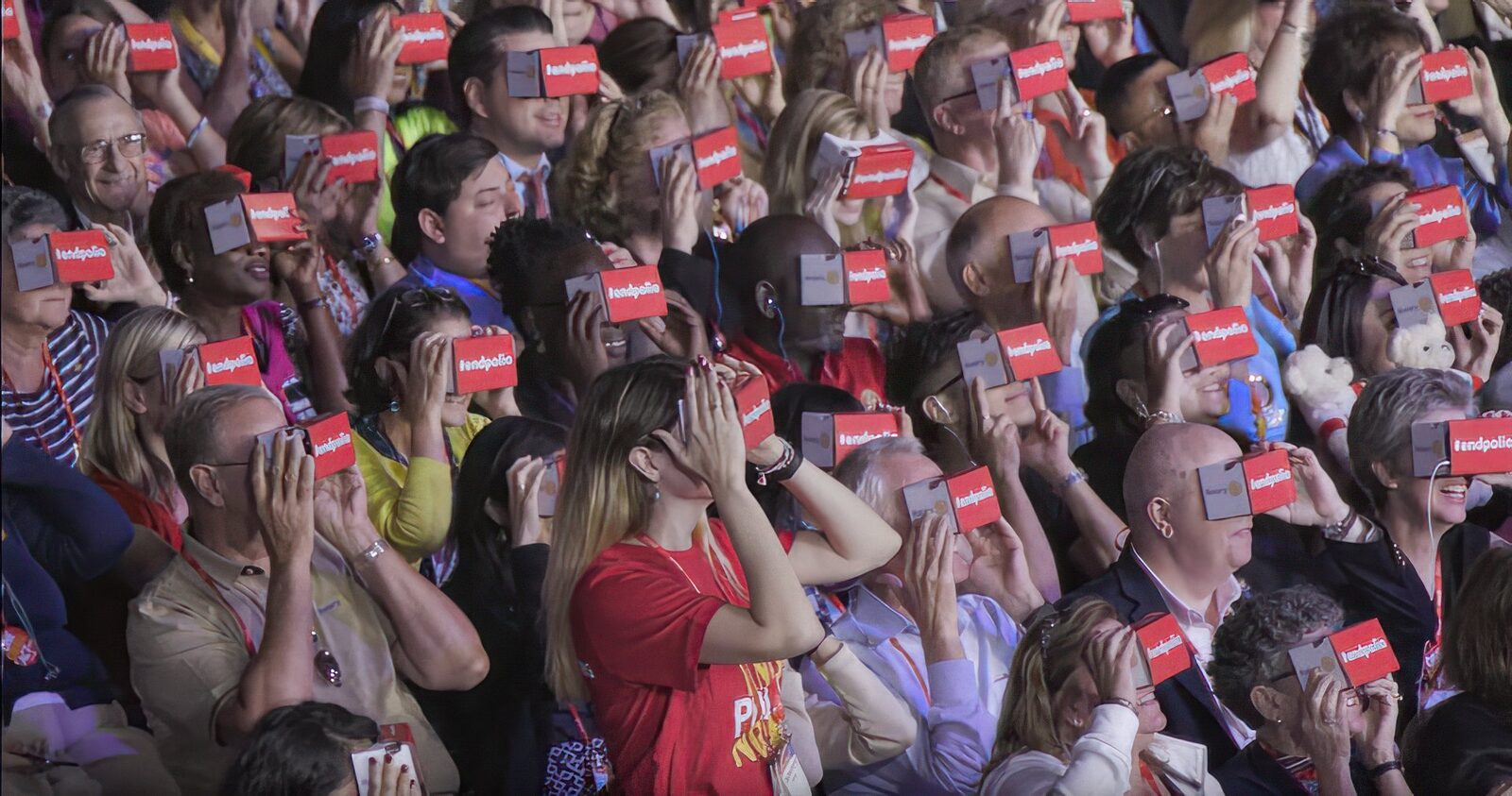 Rotary delegates watching a VR film together through red cardboard viewers