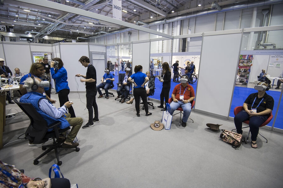 A busy Virtual Reality Zone with delegates trying the headsets