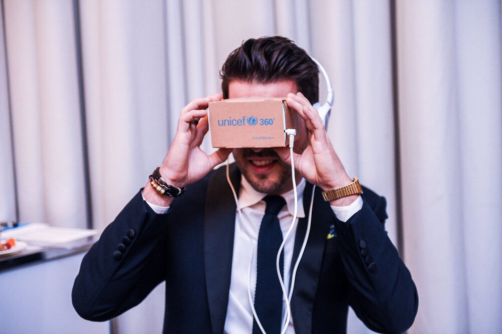 The UNICEF360 fold-flat cardboard VR viewer holding a smartphone